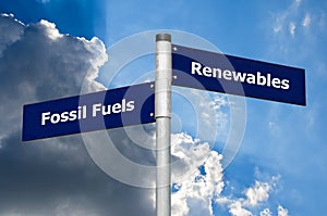 Street sign in front of cloudy sky representing choice between Ã¢â¬Ëfossil fuelsÃ¢â¬â¢ and Ã¢â¬Ërenewables`